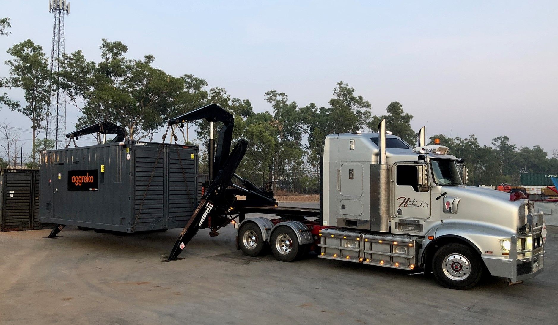 A White Container Freight Truck Is Driving On The Road — Harker Haulage In East Arm, NT