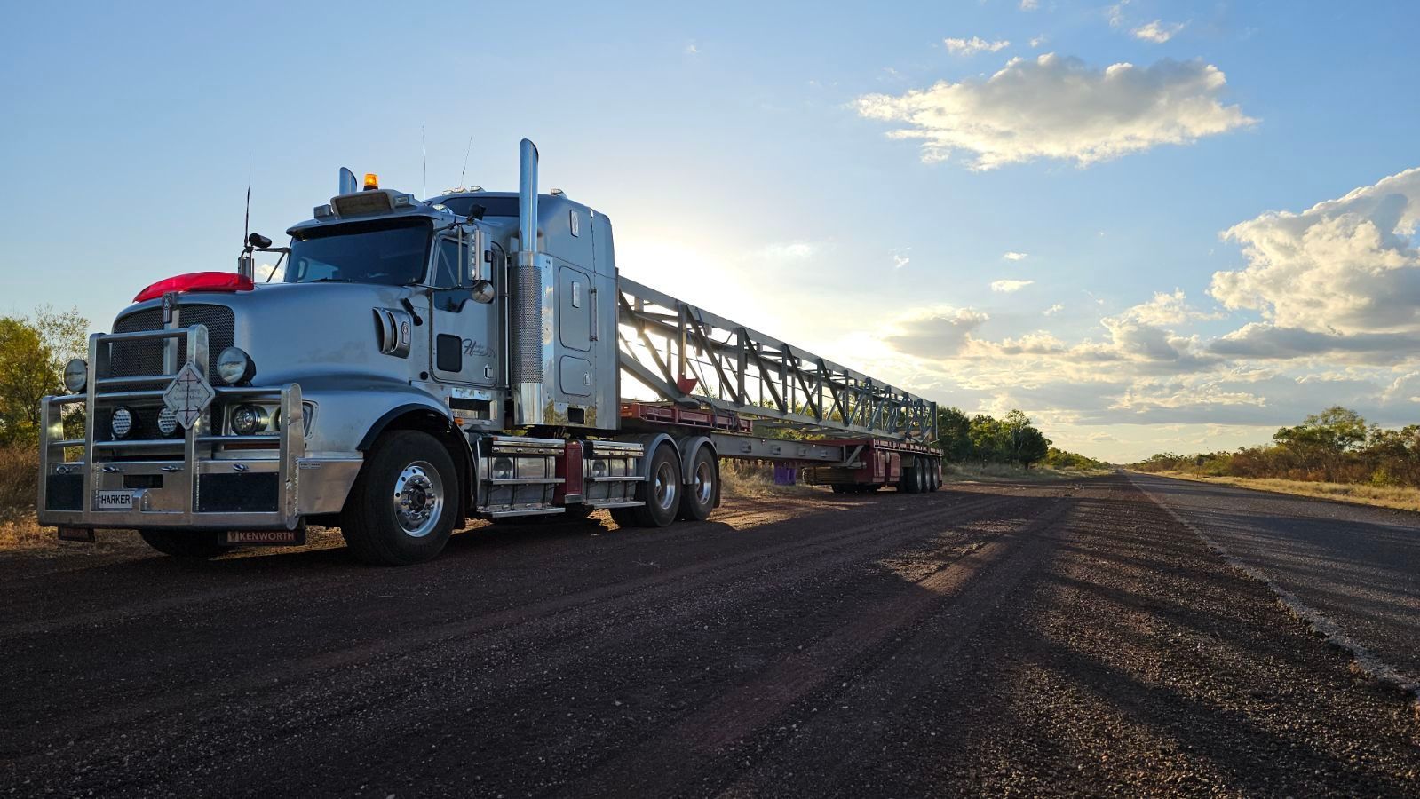 A Semi Truck is Parked in a Parking Lot at Sunset — Harker Haulage In East Arm, NT
