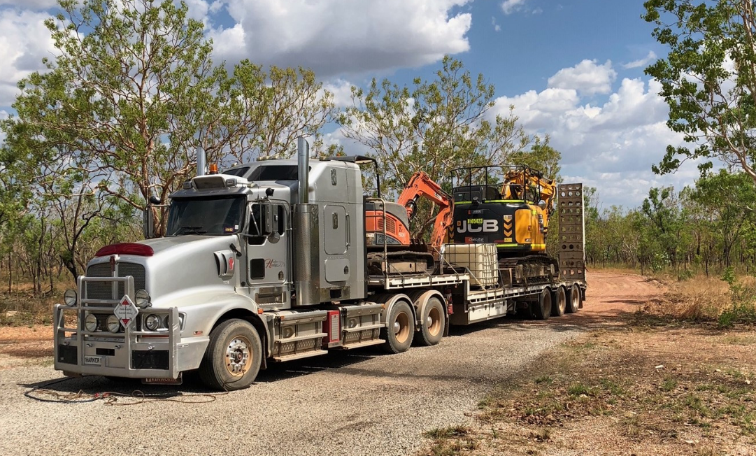 A Semi Truck is Carrying a Bulldozer on a Trailer — Harker Haulage In East Arm, NT