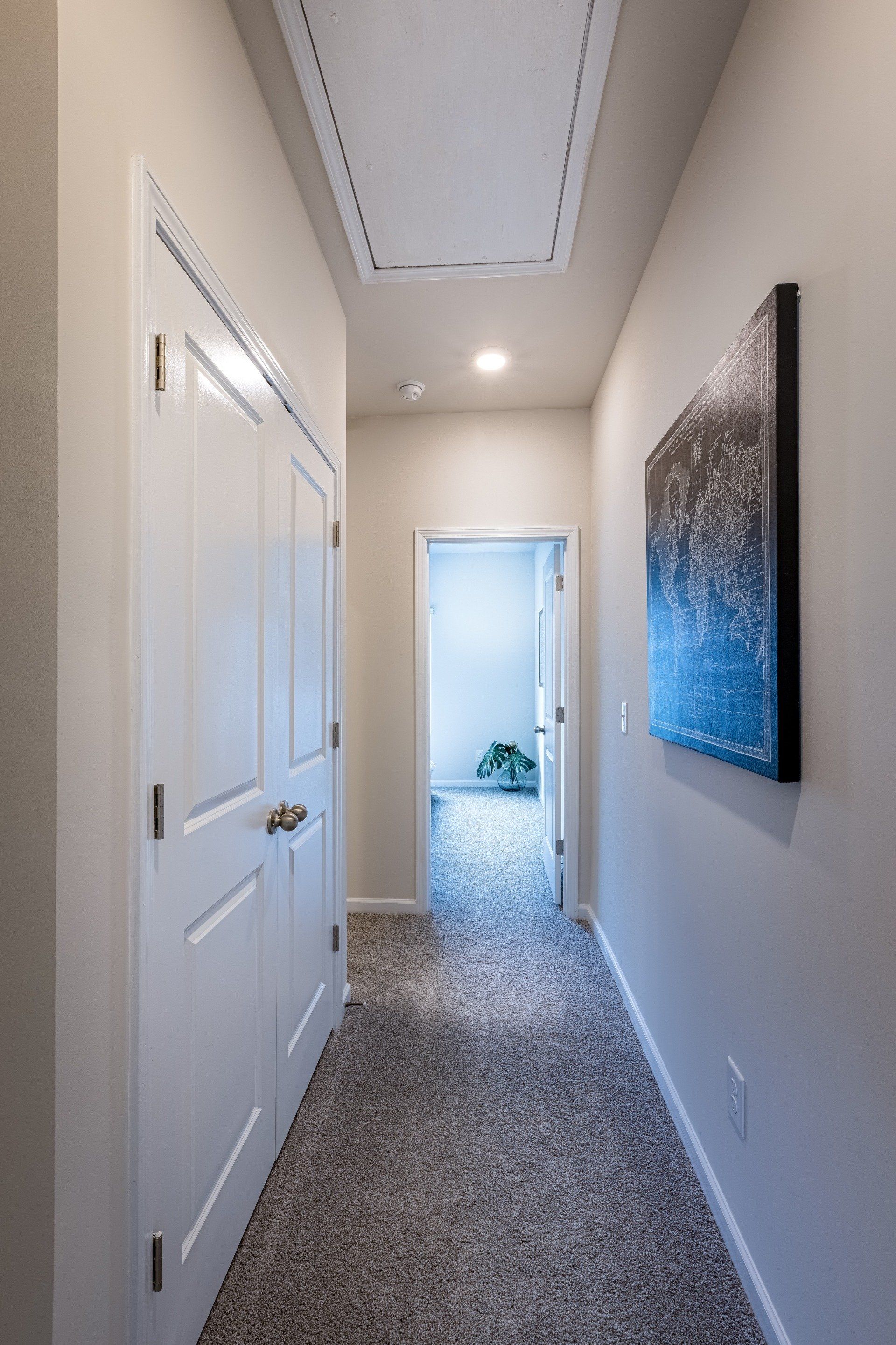 Hallway interior of Beatty Woods Townhomes featuring clean lines and modern lighting.