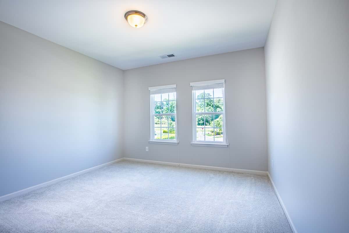 Additional bedroom in Water’s Edge Parkview Series suitable for various needs.