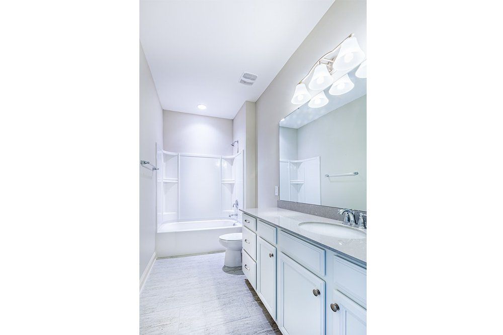Second bathroom in Water’s Edge Parkview Series with modern fixtures and clean design.