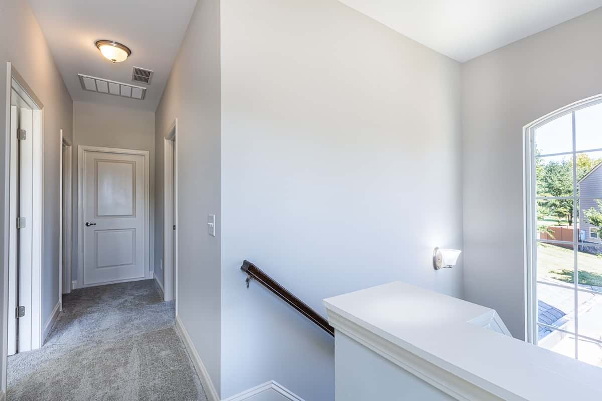 Upstairs hallway in Water’s Edge Parkview Series connecting bedrooms and bathroom.