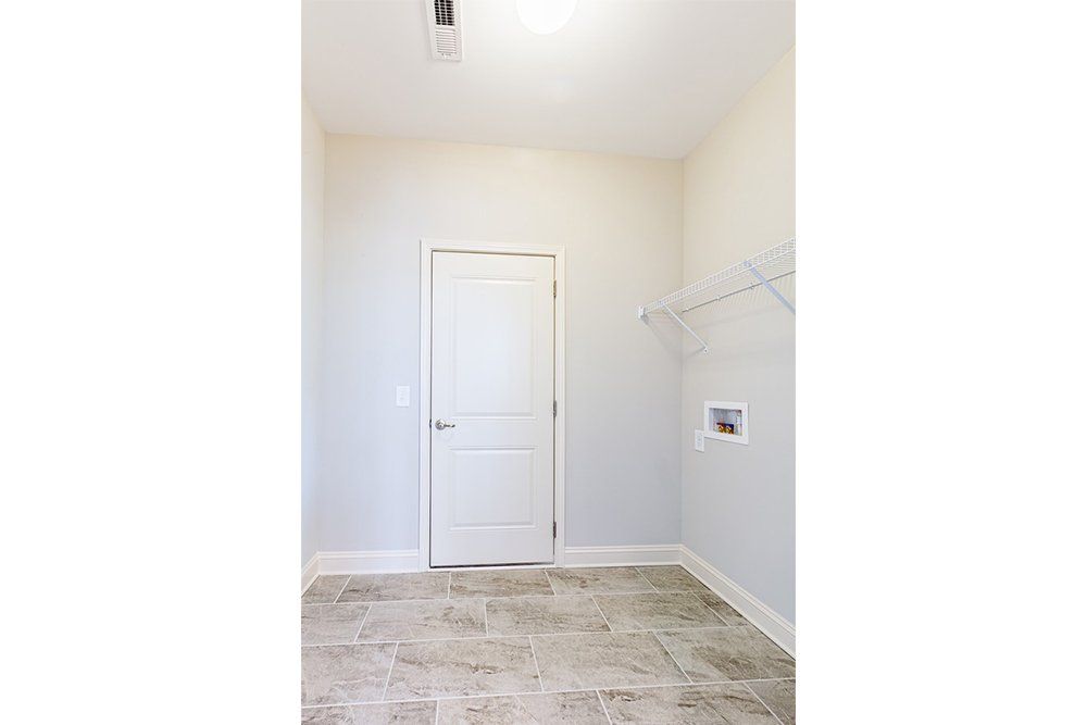 Laundry room in Water’s Edge Parkview Series featuring functional layout and storage space.