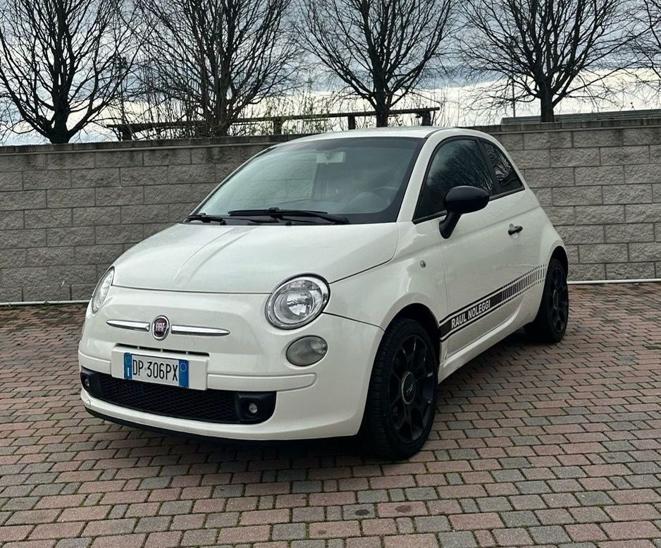 Una Mercedes Benz Classe C Station Wagon bianca è parcheggiata su un vialetto in mattoni.