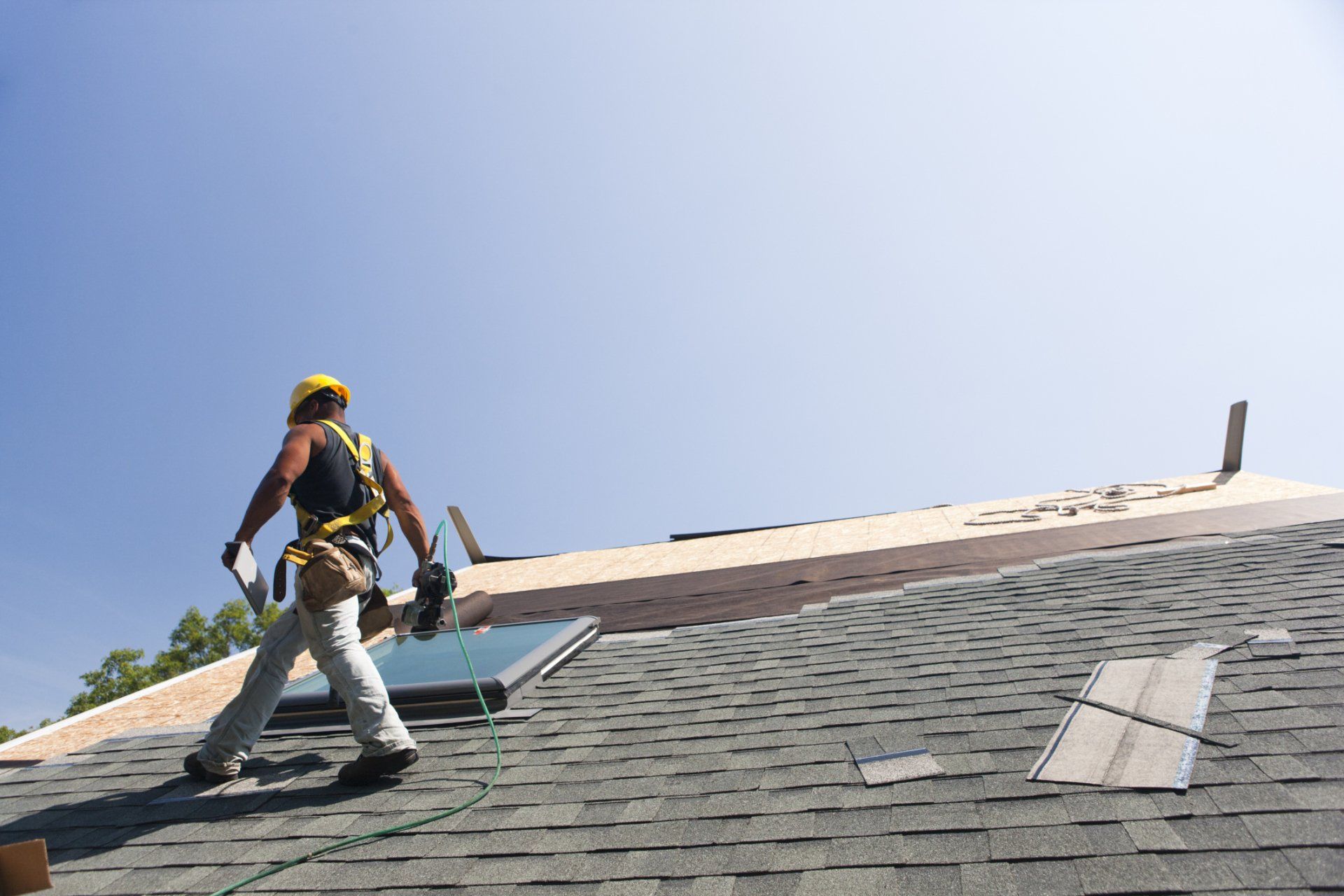 Man Walking on Residential roof - Roofing services in Hicksville, NY