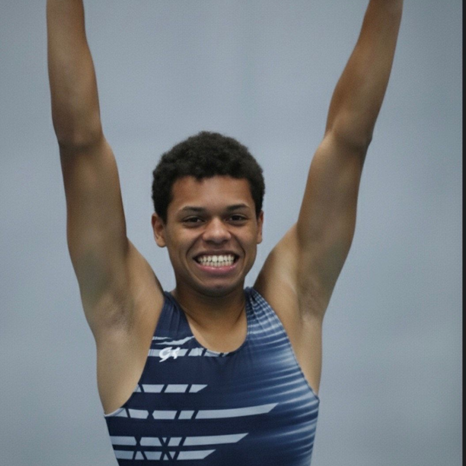 A woman wearing a flower crown is smiling for the camera