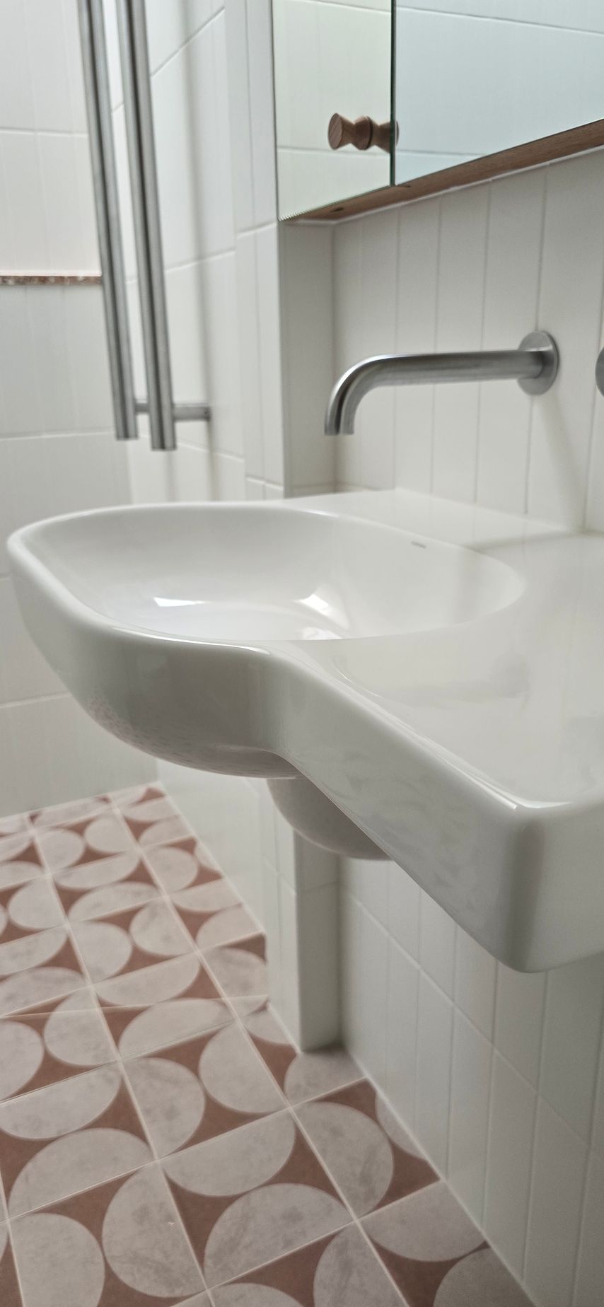 A bathroom sink with a faucet and a mirror.