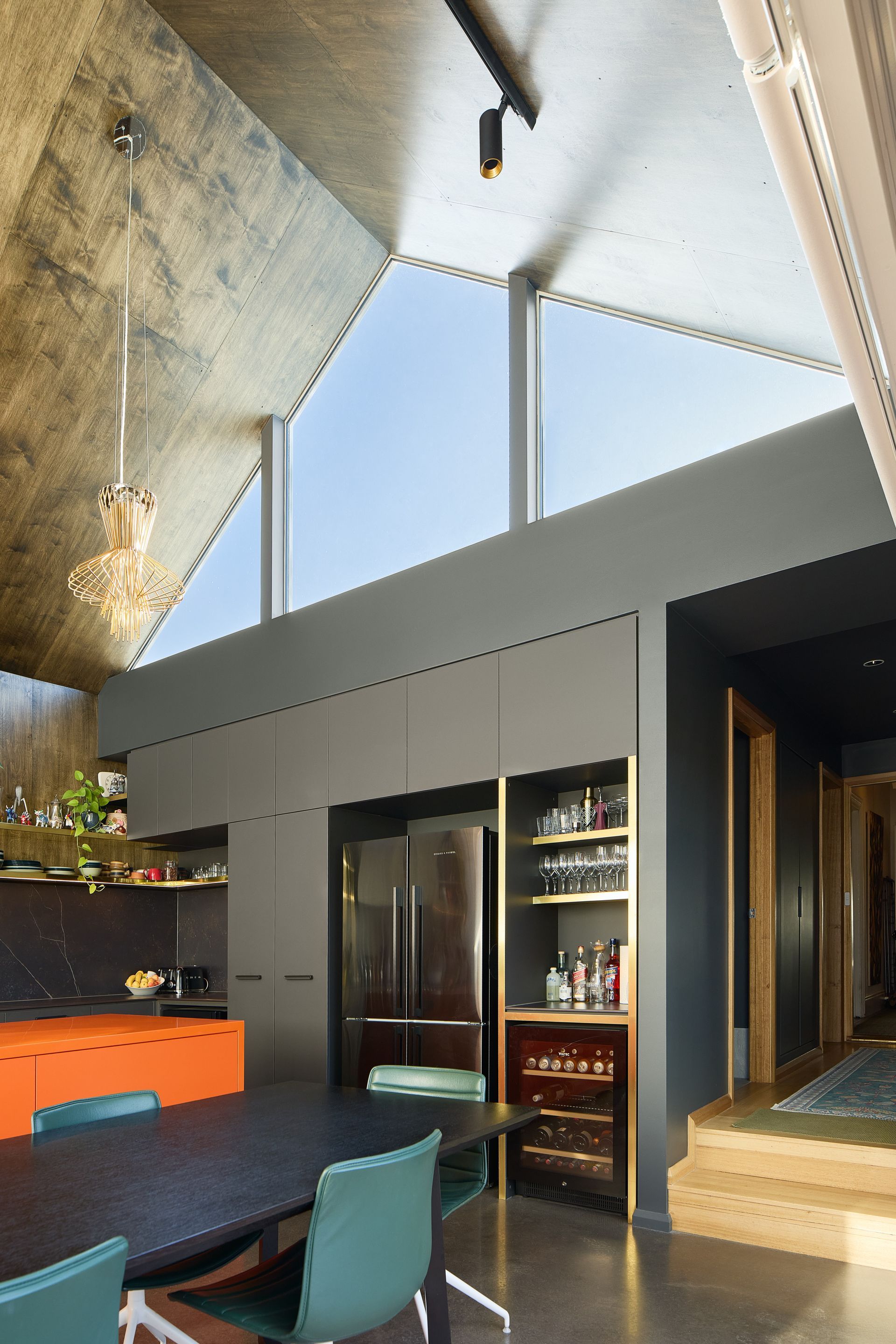 A kitchen with a table and chairs and a large window