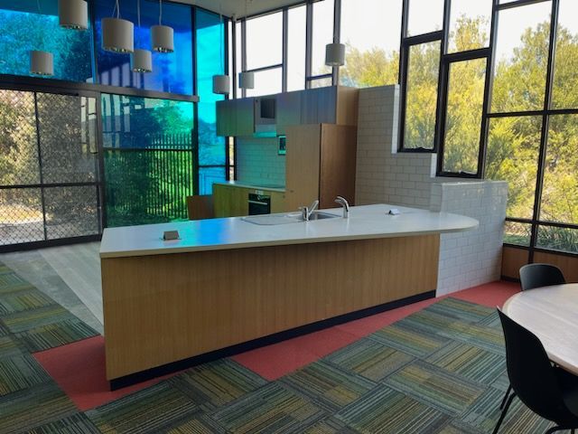 A kitchen with a large island and lots of windows