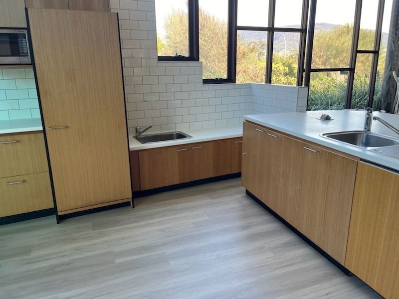 A kitchen with wooden cabinets and a sink