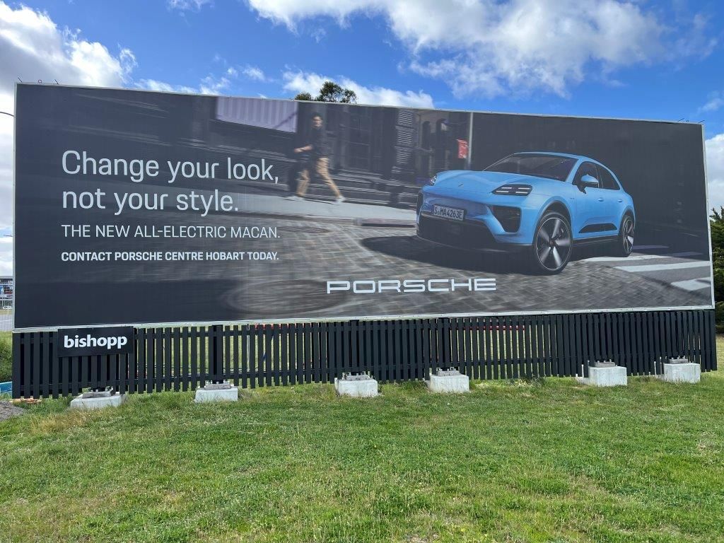 A large billboard for porsche says change your look not your style