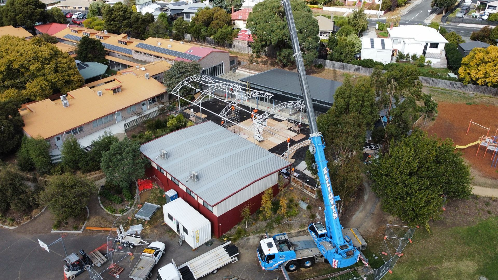 An aerial view of a building being built with a crane.