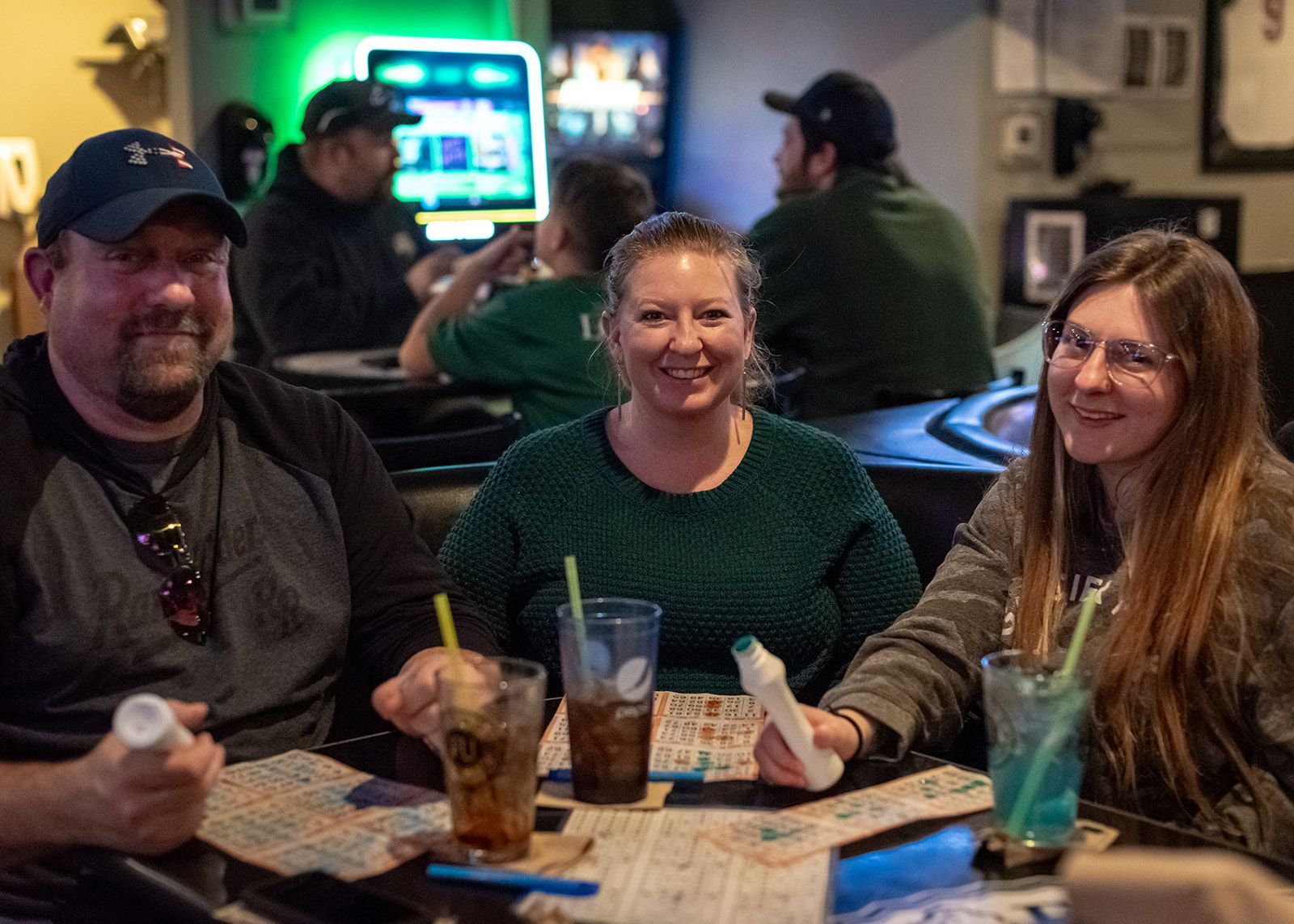 A group of people are sitting at a table playing bingo.