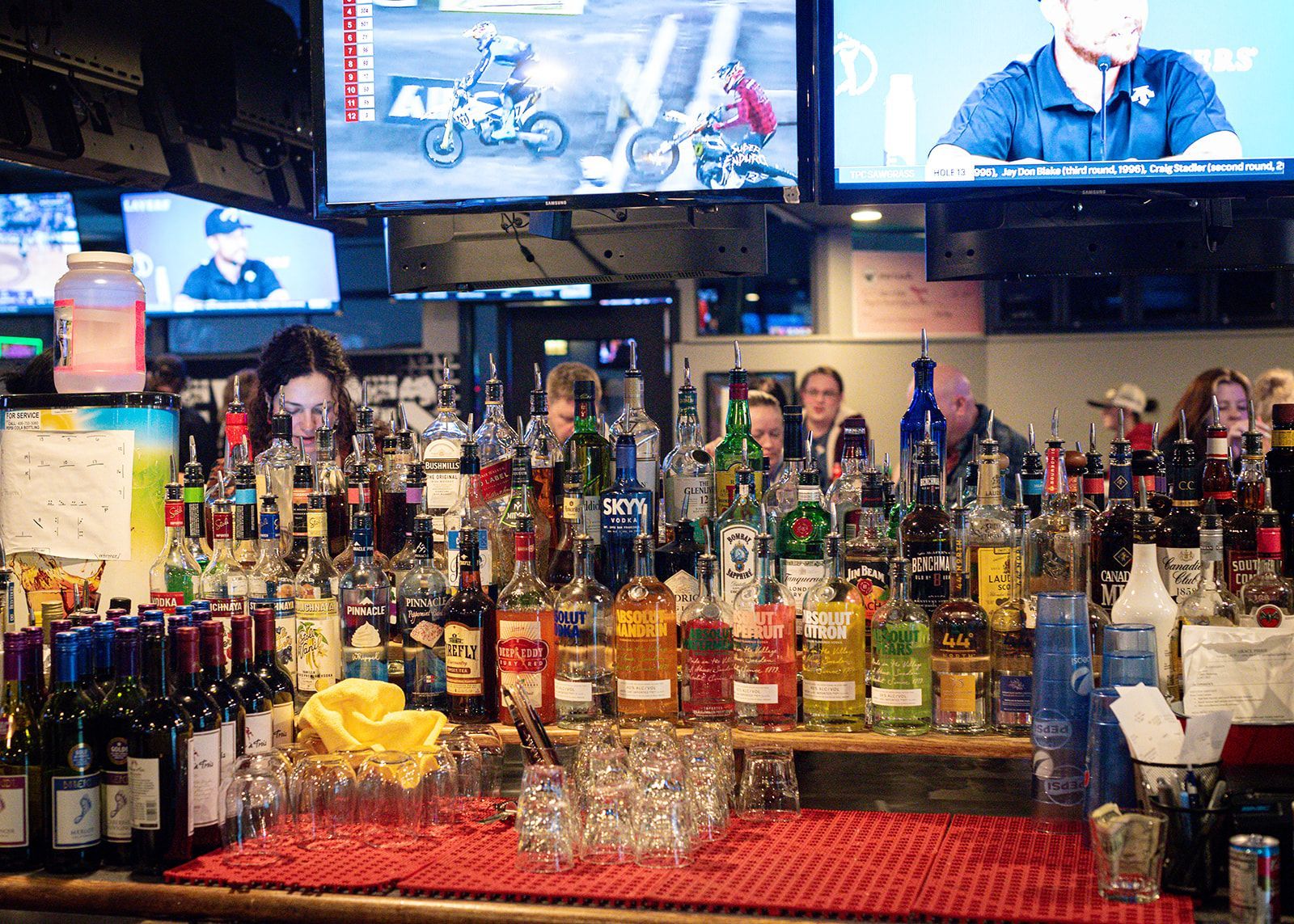 A bar filled with lots of bottles and glasses