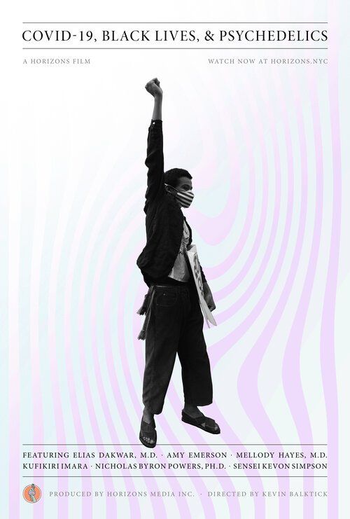 A black and white photo of a person with their fist in the air.