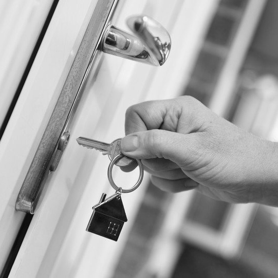 A key going into a lock on a uPVC door