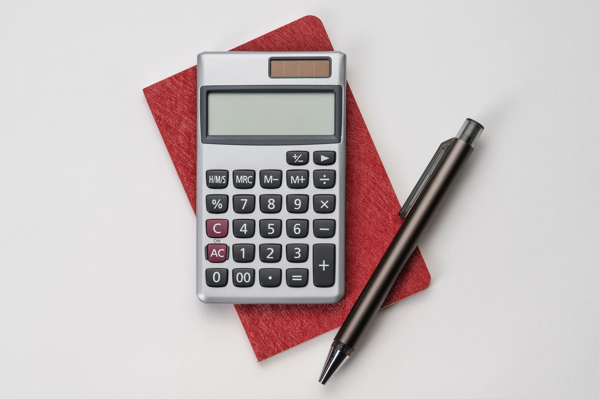 Calculator, Pen and Red Notebook