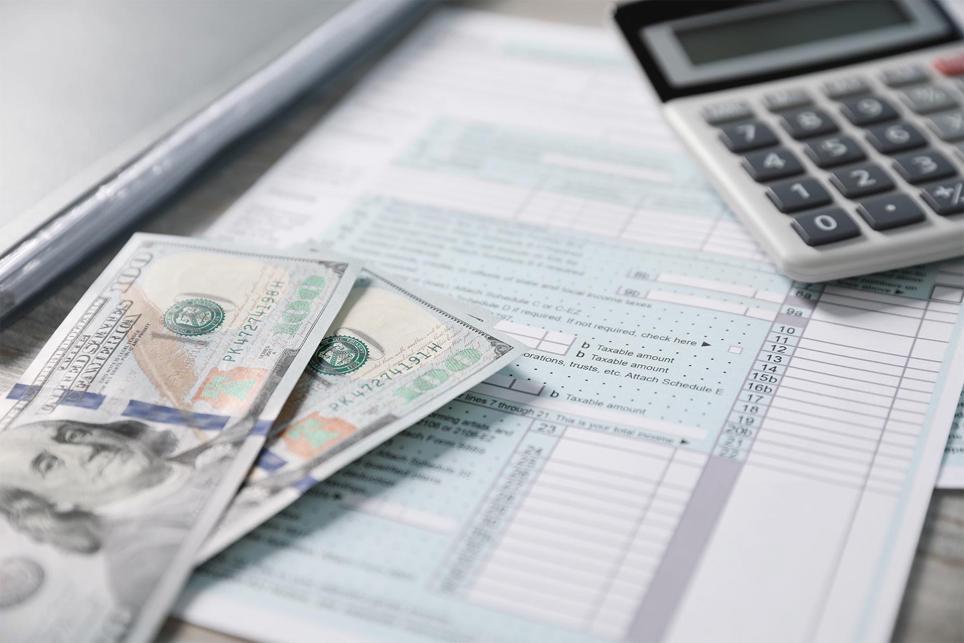 Payroll Form, Dollar Bills and Calculator