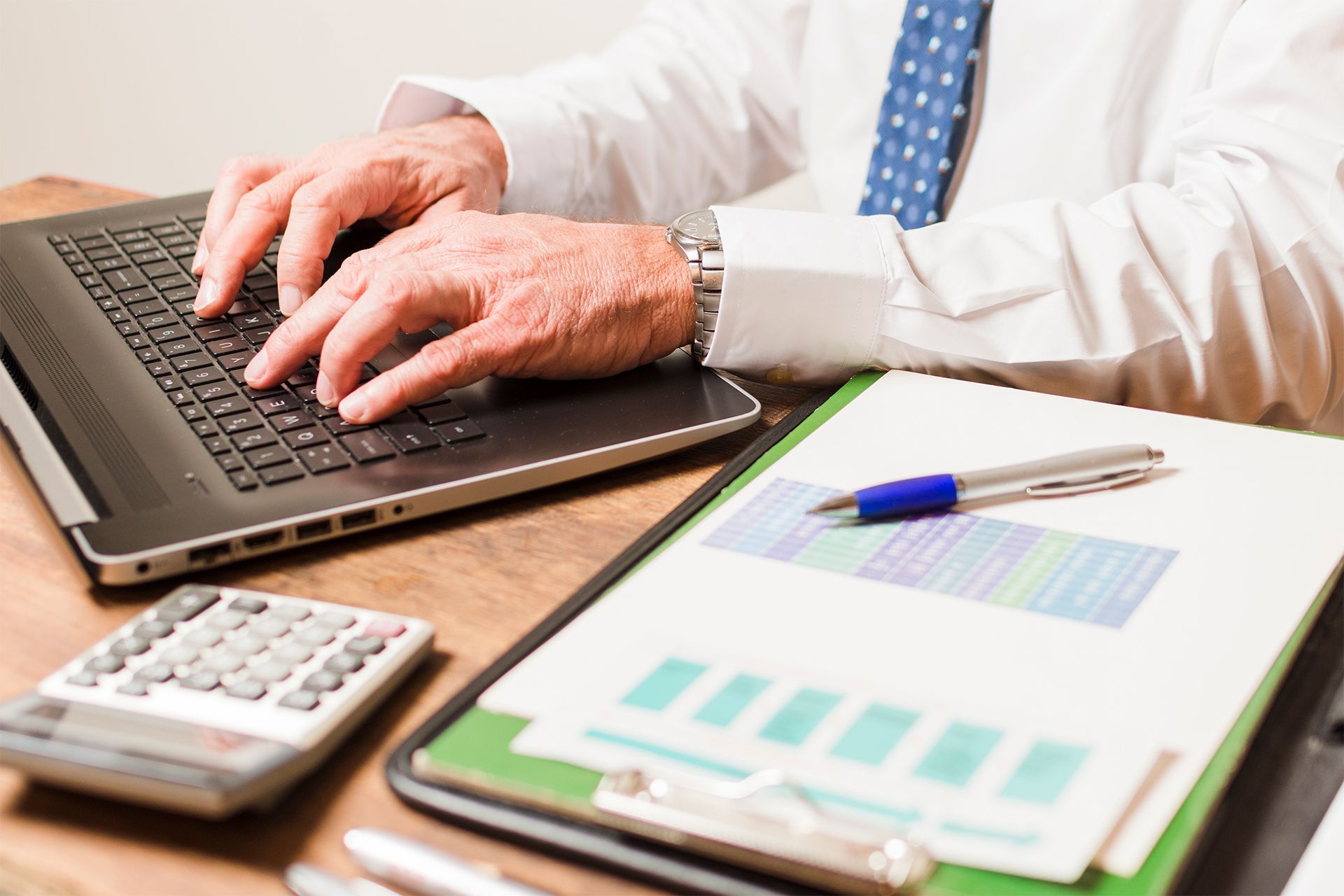 Accountant Typing on a Laptop