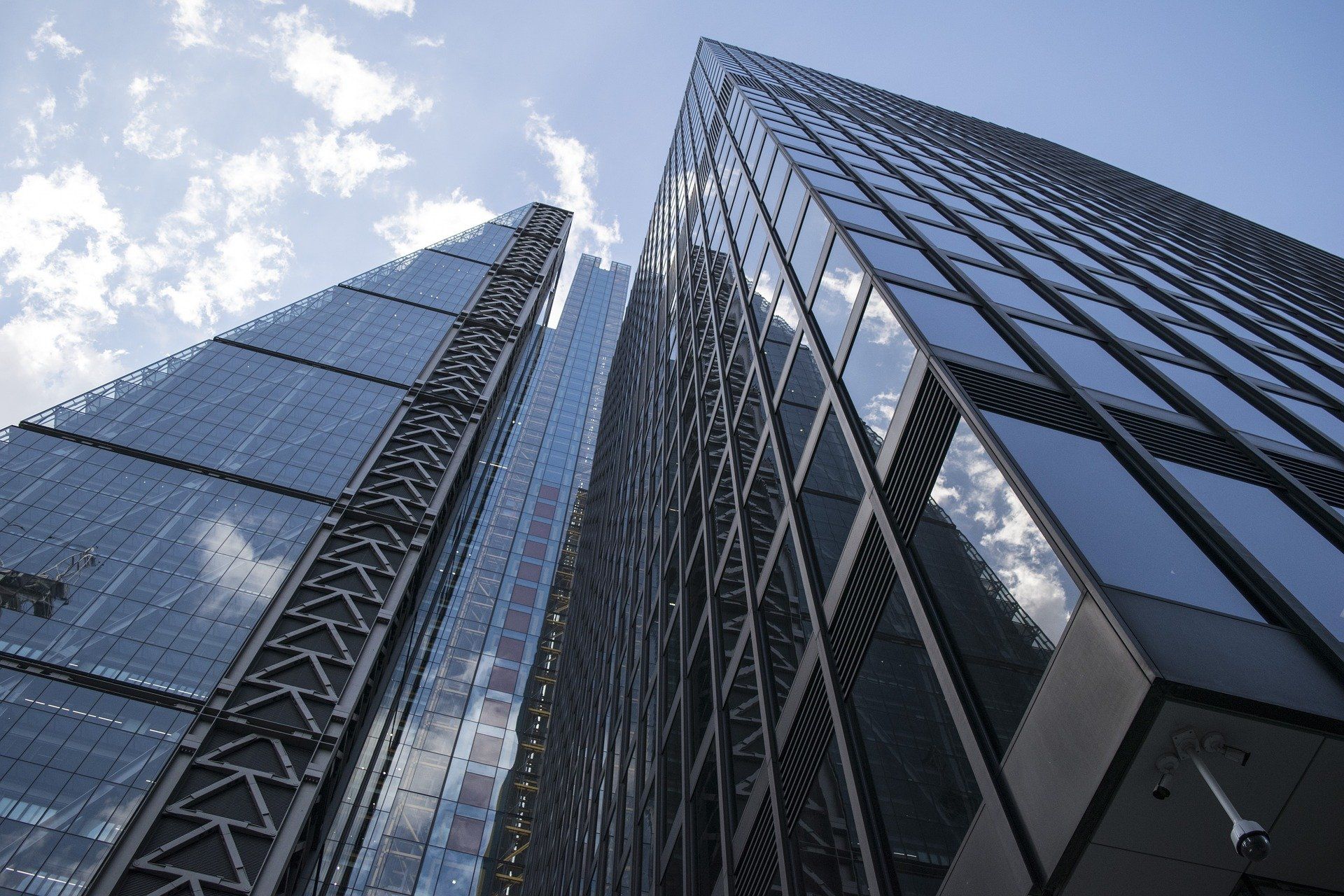Looking up at a tall building with a blue sky in the background