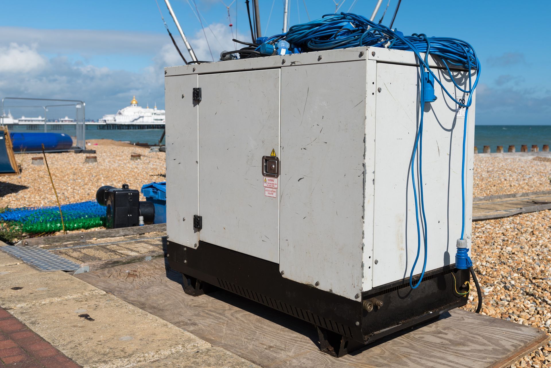 A diesel powered electricity generator and cables. A diesel powered electricity generator and cables.