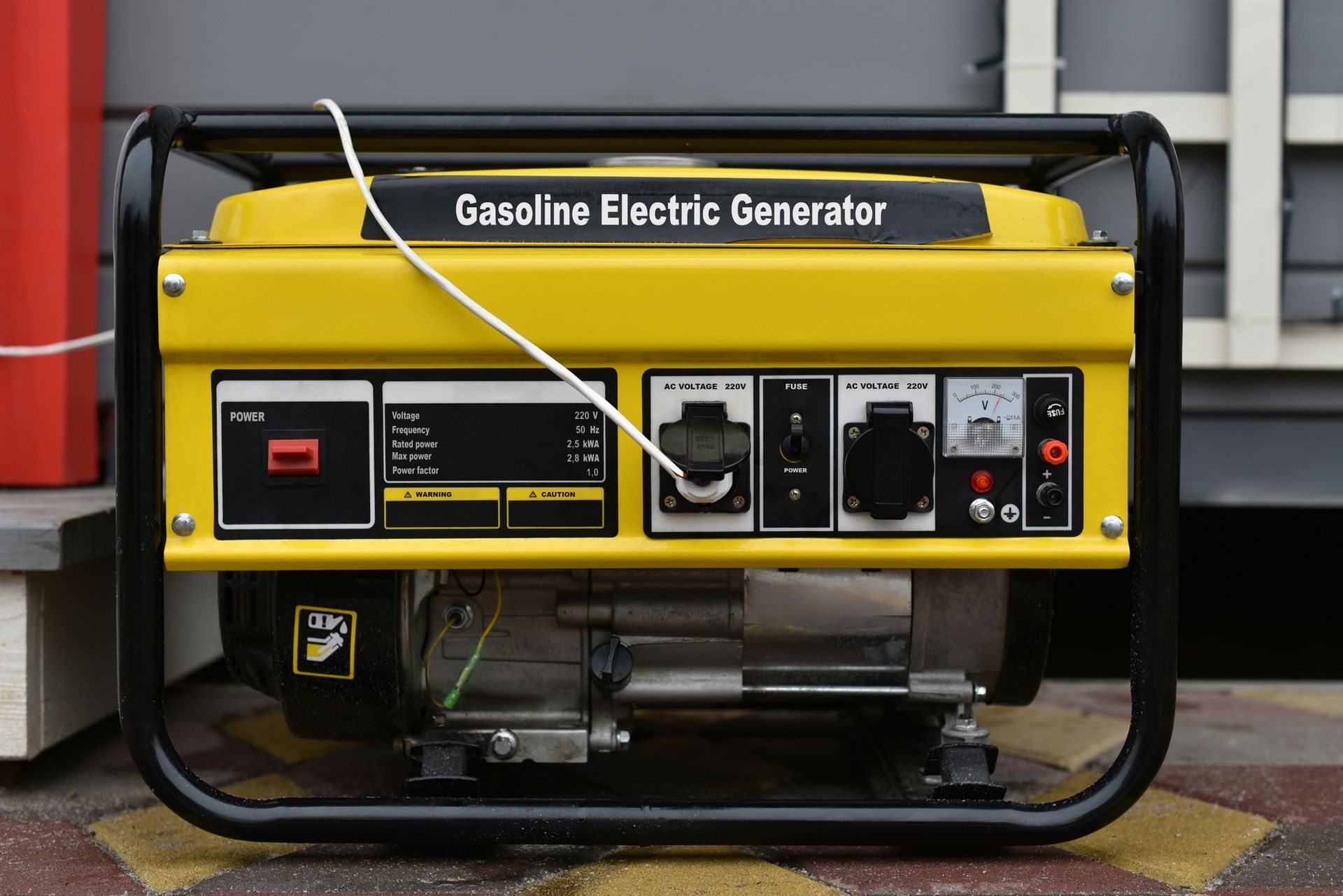 A yellow gasoline generator with a control panel and outlets, placed on a tiled indoor floor A yellow gasoline generator with a control panel and outlets, placed on a tiled indoor floor