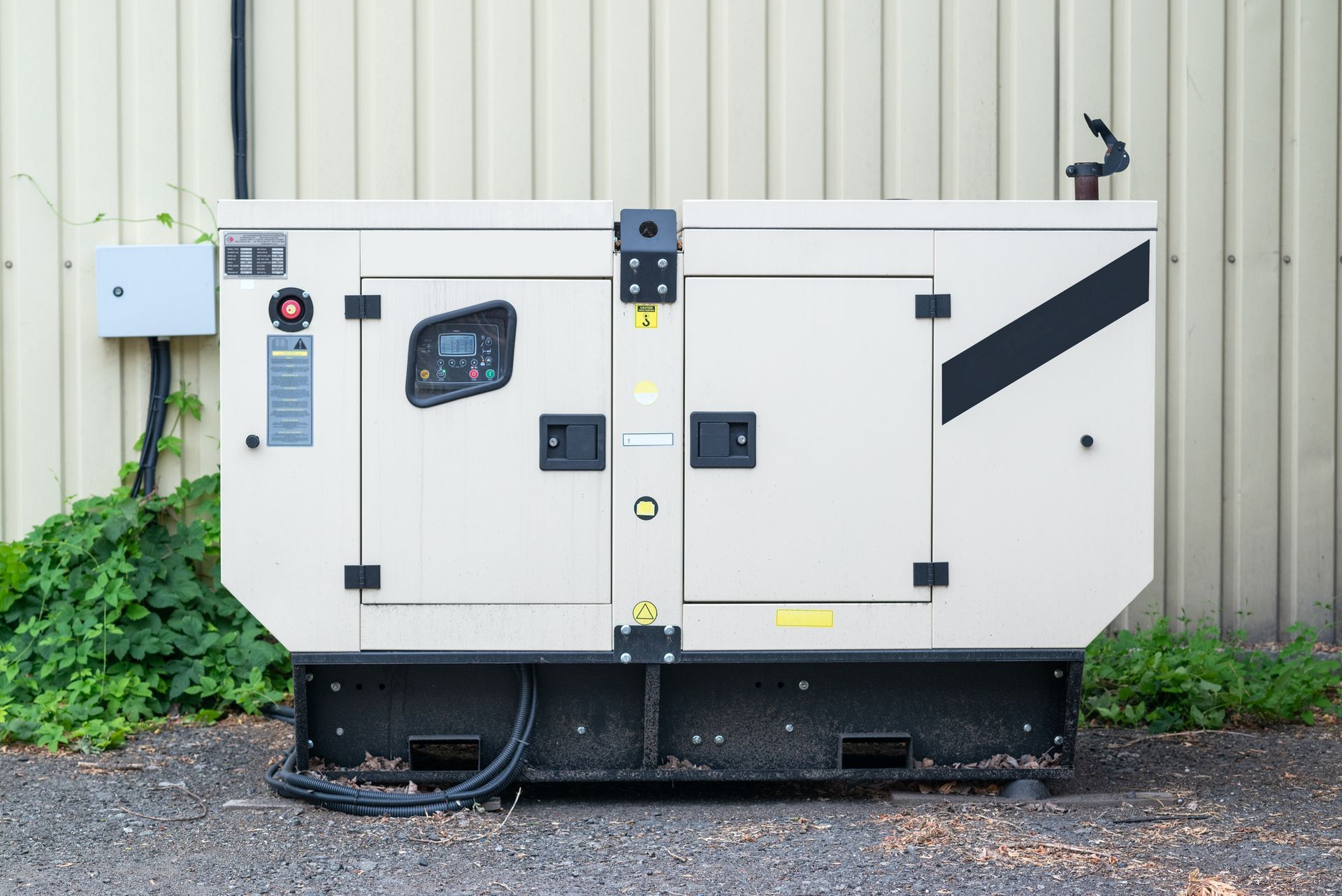 A man in a suit inspecting a portable generator in a store showroom