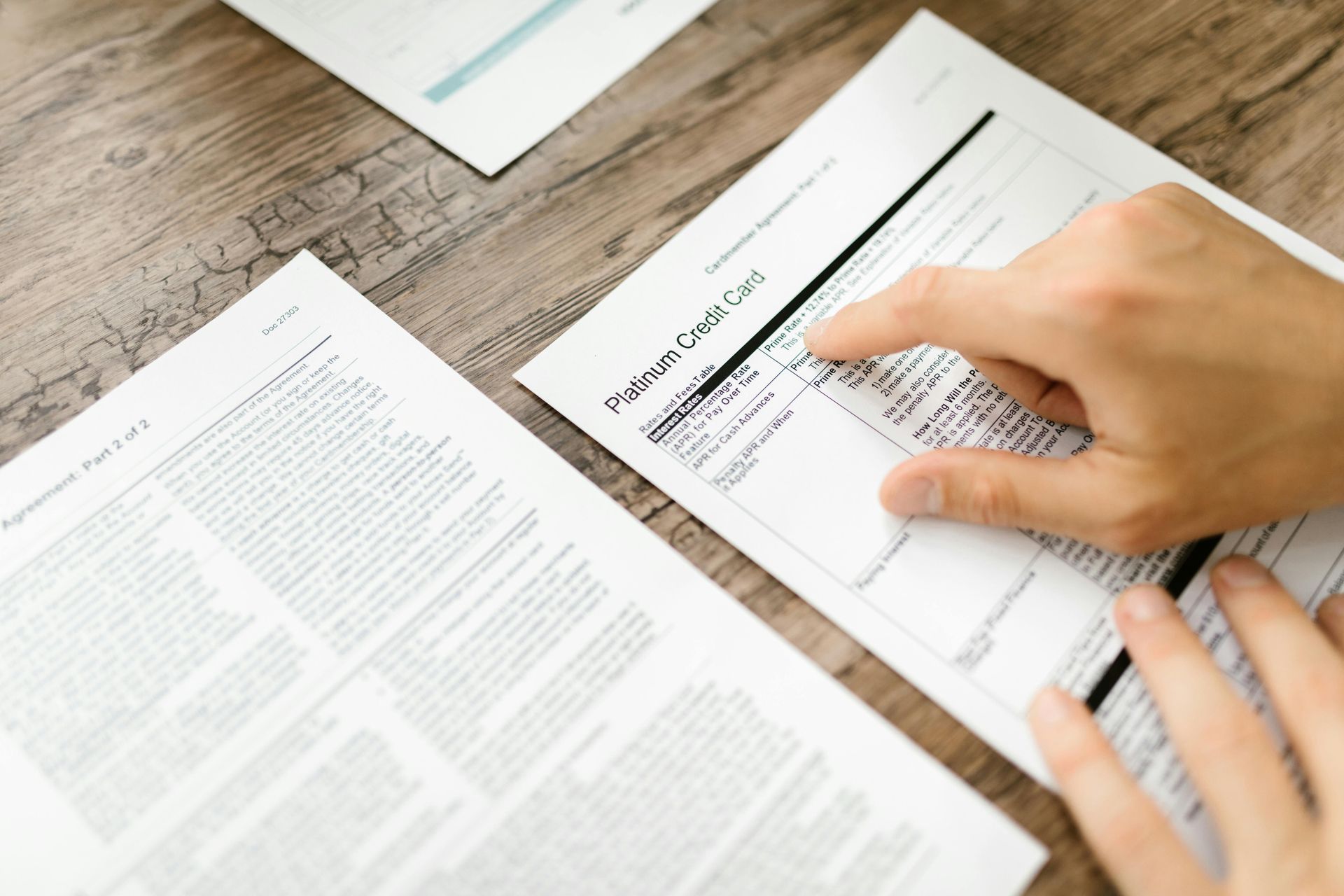 A hand points to a section on a printed 