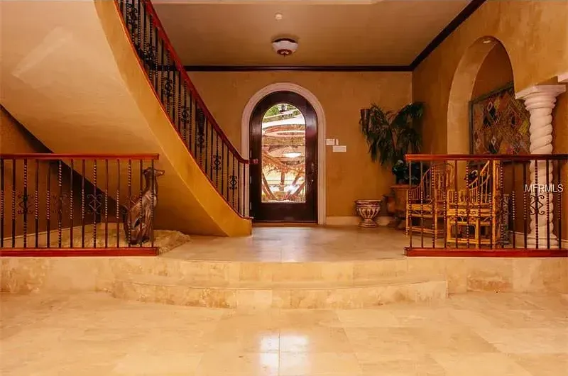 A staircase leading up to a door in a house