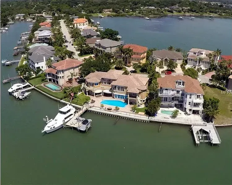 An aerial view of a residential area next to a body of water