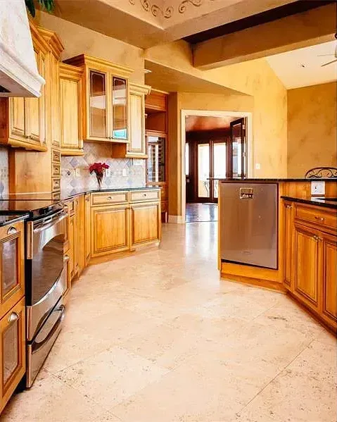 A kitchen with wooden cabinets and stainless steel appliances.