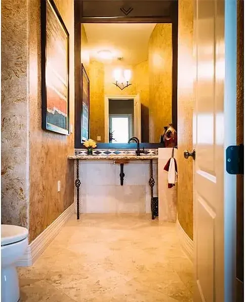 A bathroom with a sink , toilet and mirror.