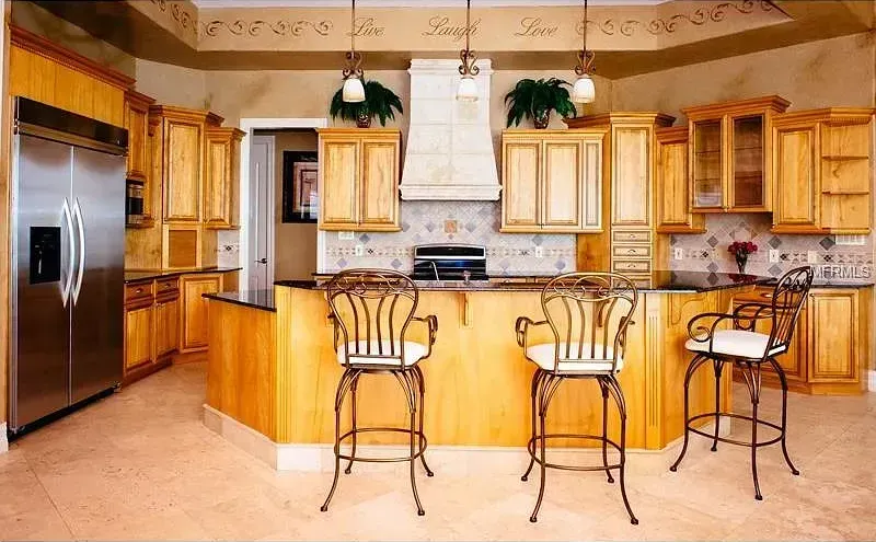 A kitchen with stainless steel appliances and wooden cabinets
