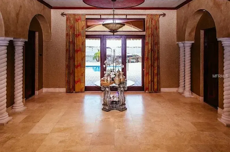 A large room with a table in the middle of it.