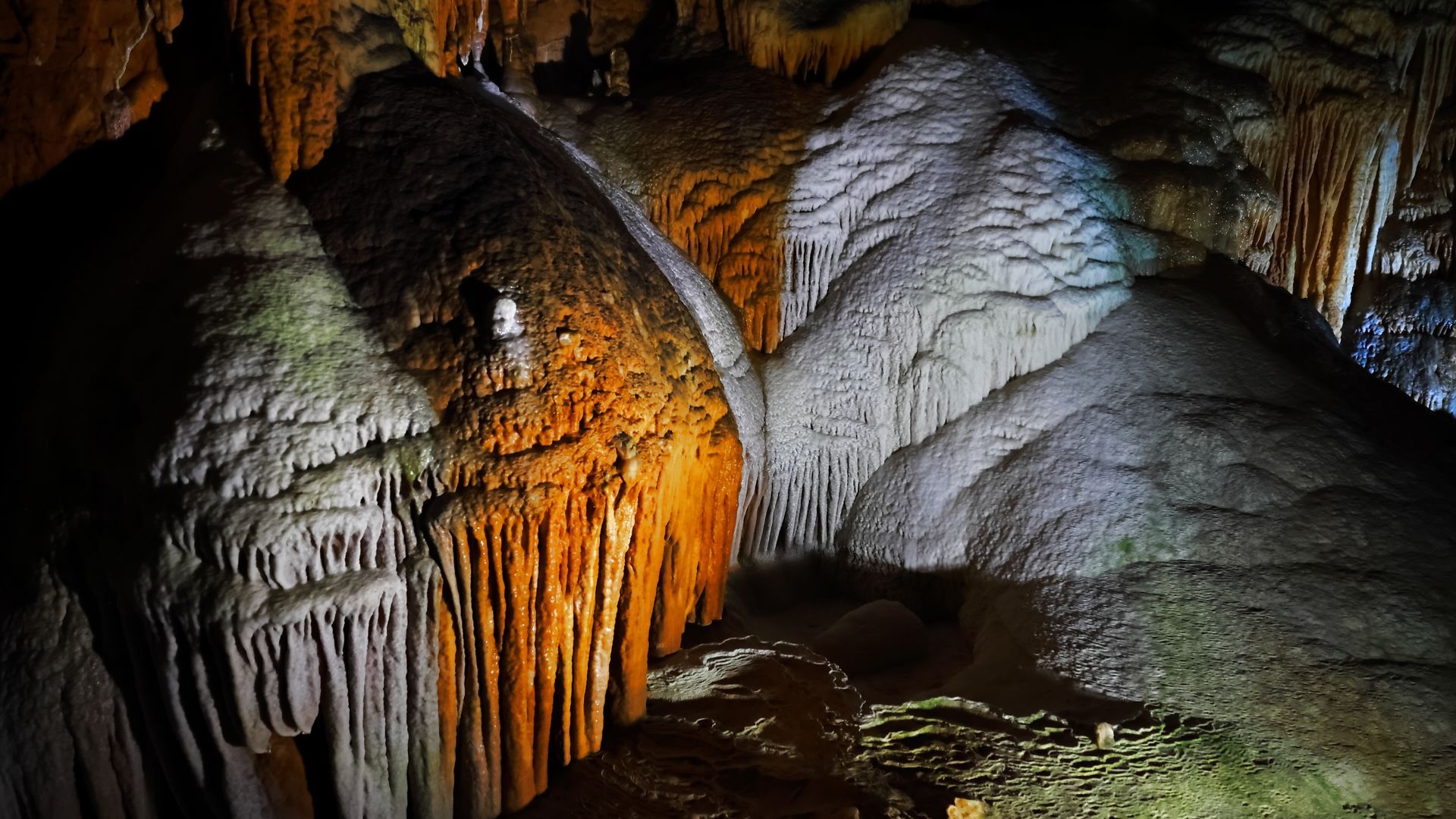 A cave with a lot of rocks and water in it.
