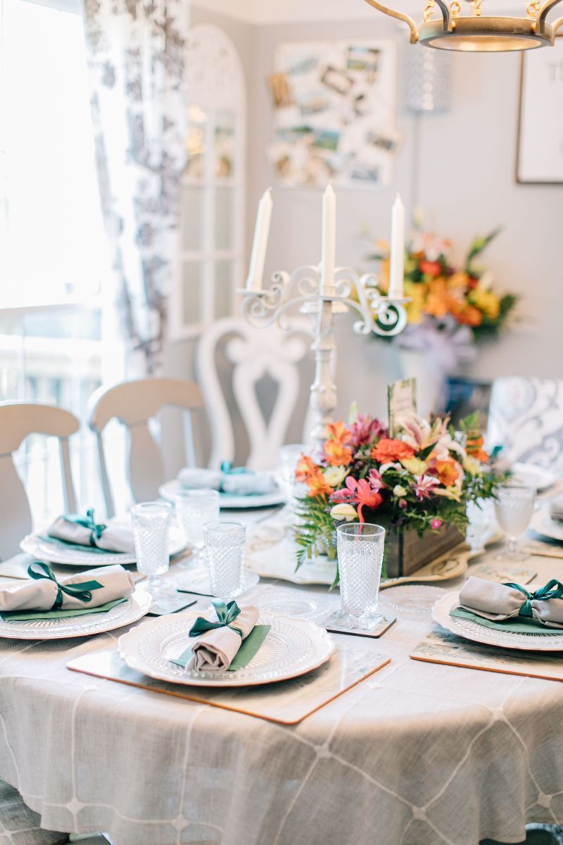 a table is set with plates glasses and candles