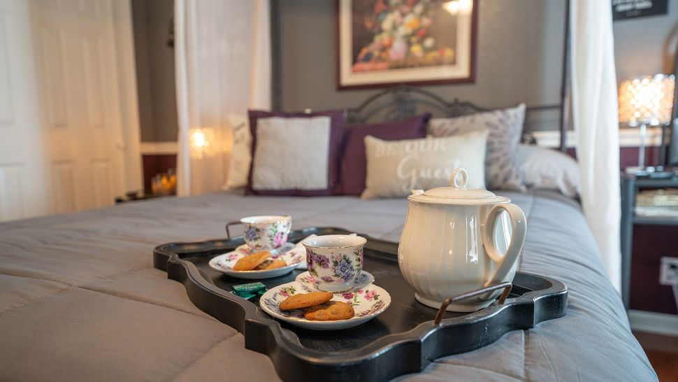 a tray of tea and cookies on a bed