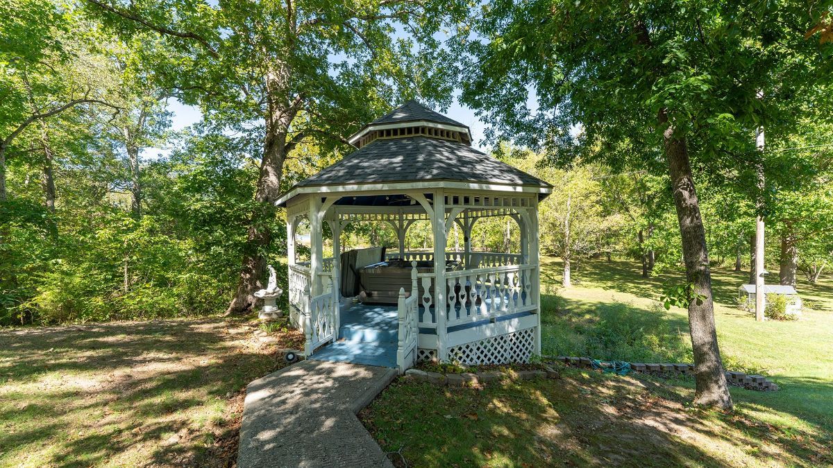 a gazebo with a hot tub inside of it