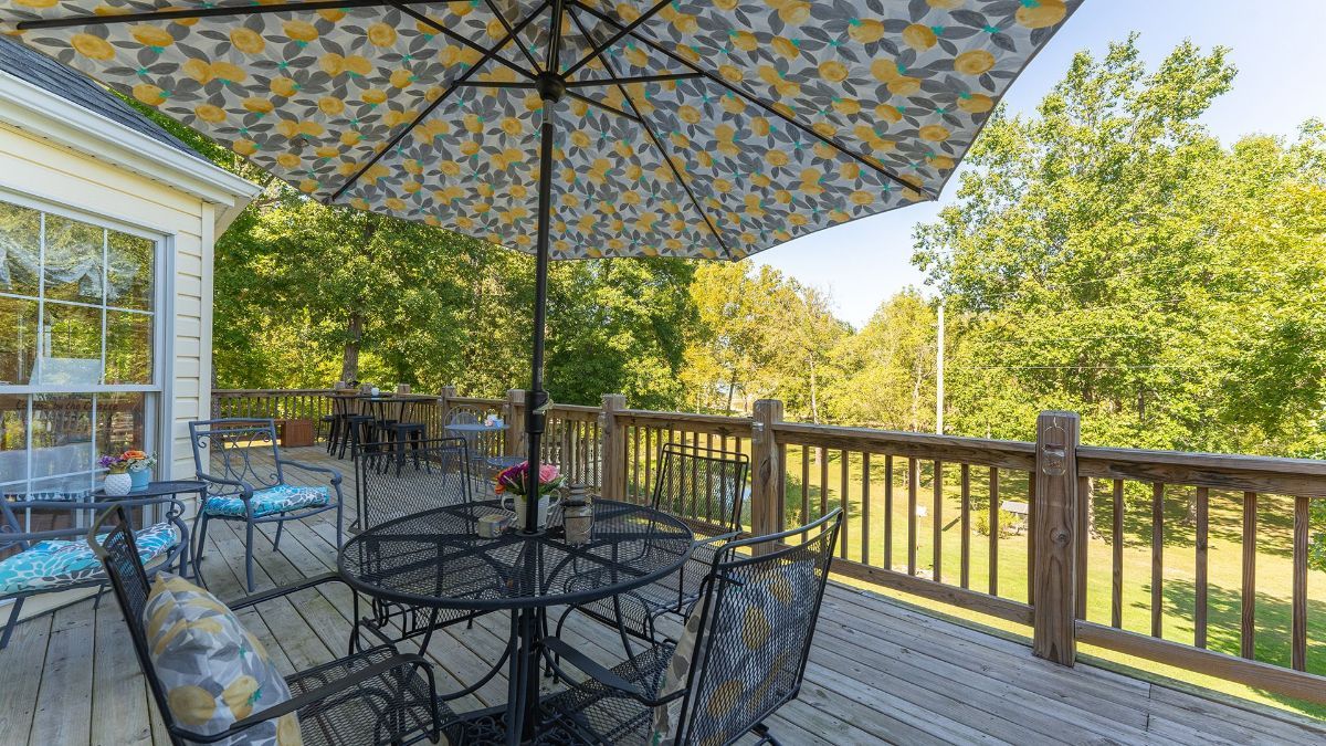 our large deck with a covered table and plenty of seating