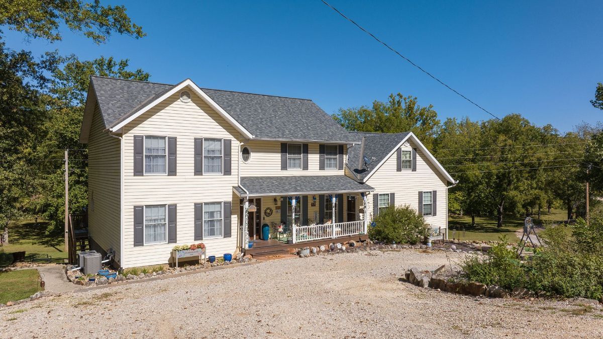 our large white house with a gray roof and black shutters