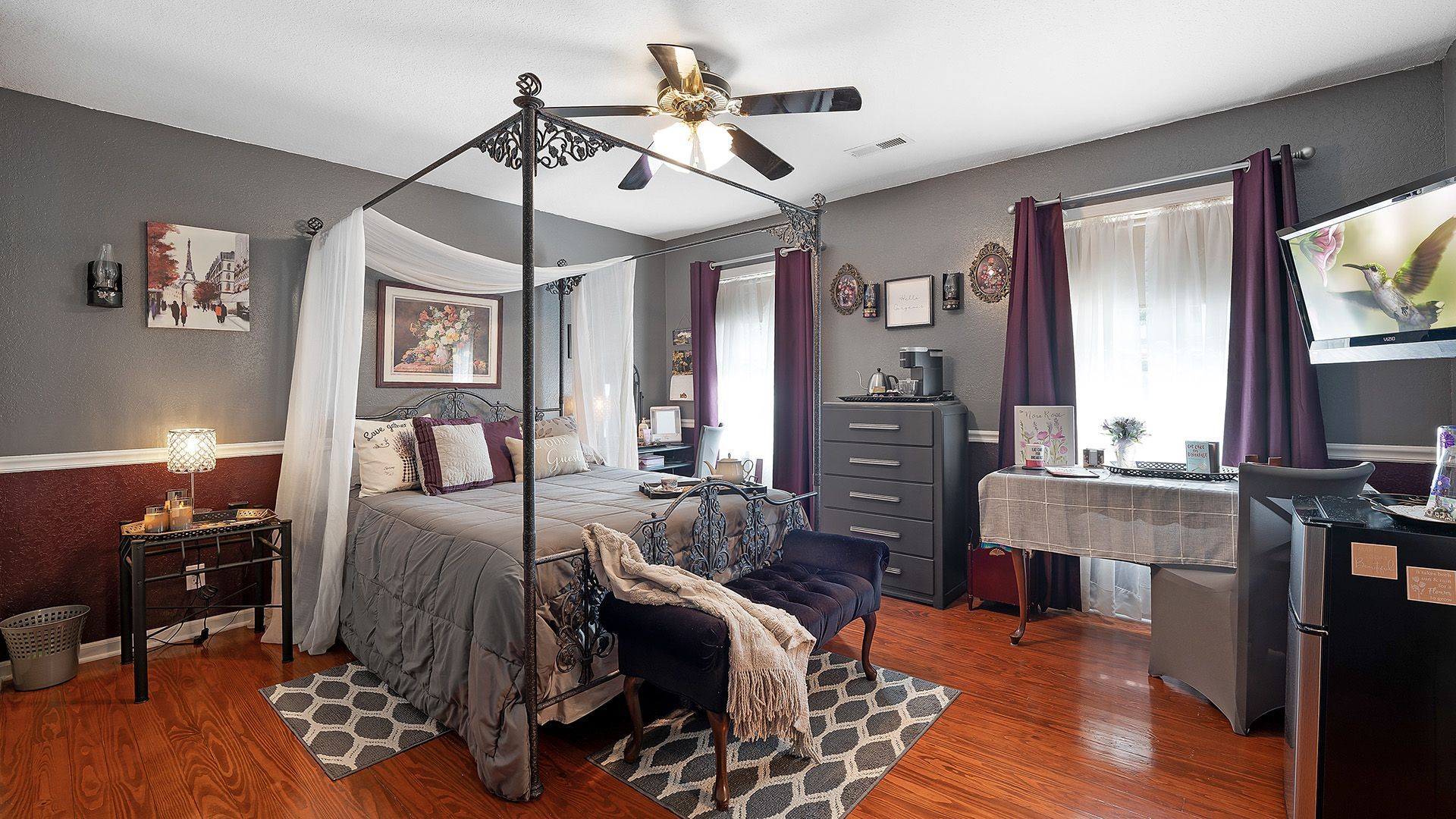 a bedroom with a canopy bed and a ceiling fan