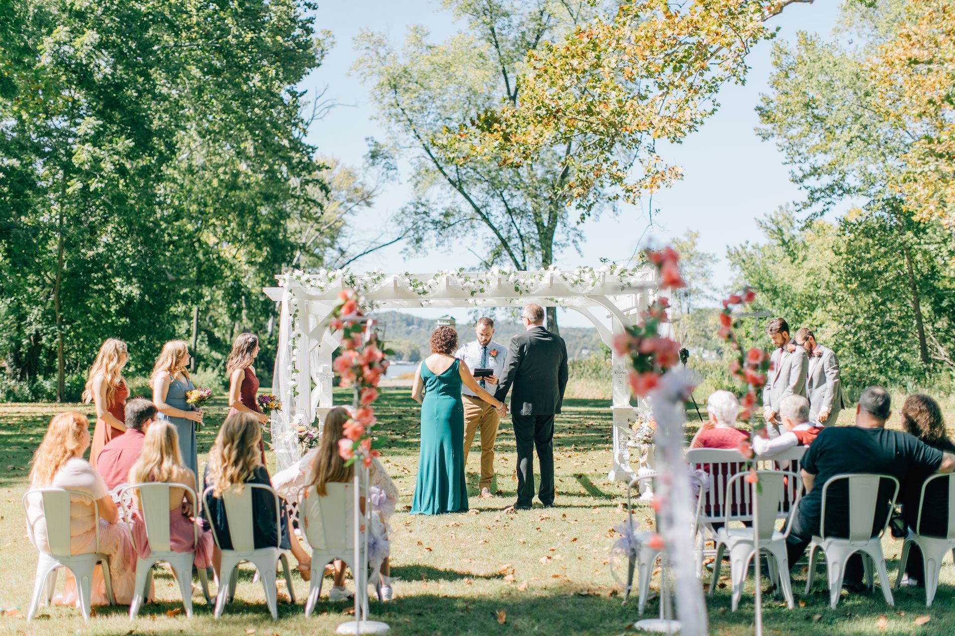 the bride and groom are holding hands during their wedding ceremony