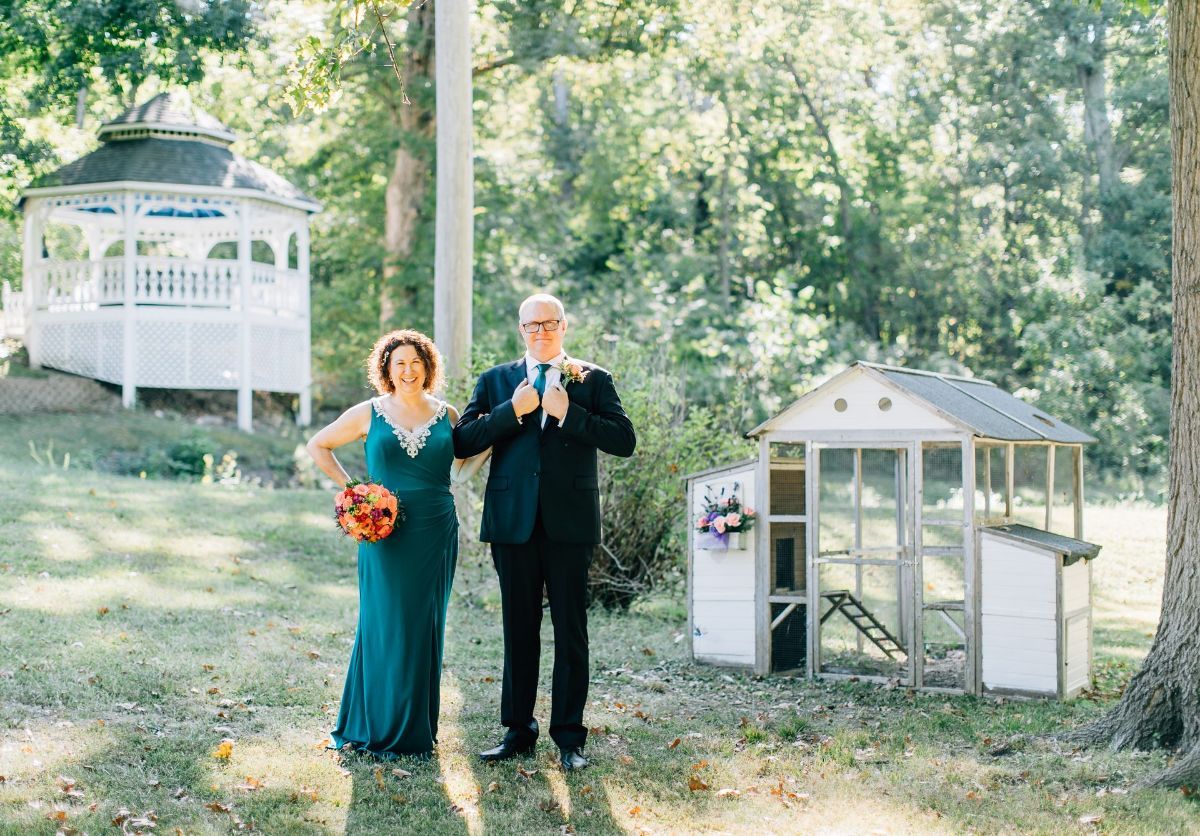 bride and groom walking through our large backyard