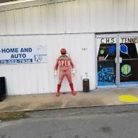 A person in a red morph suit with the word 