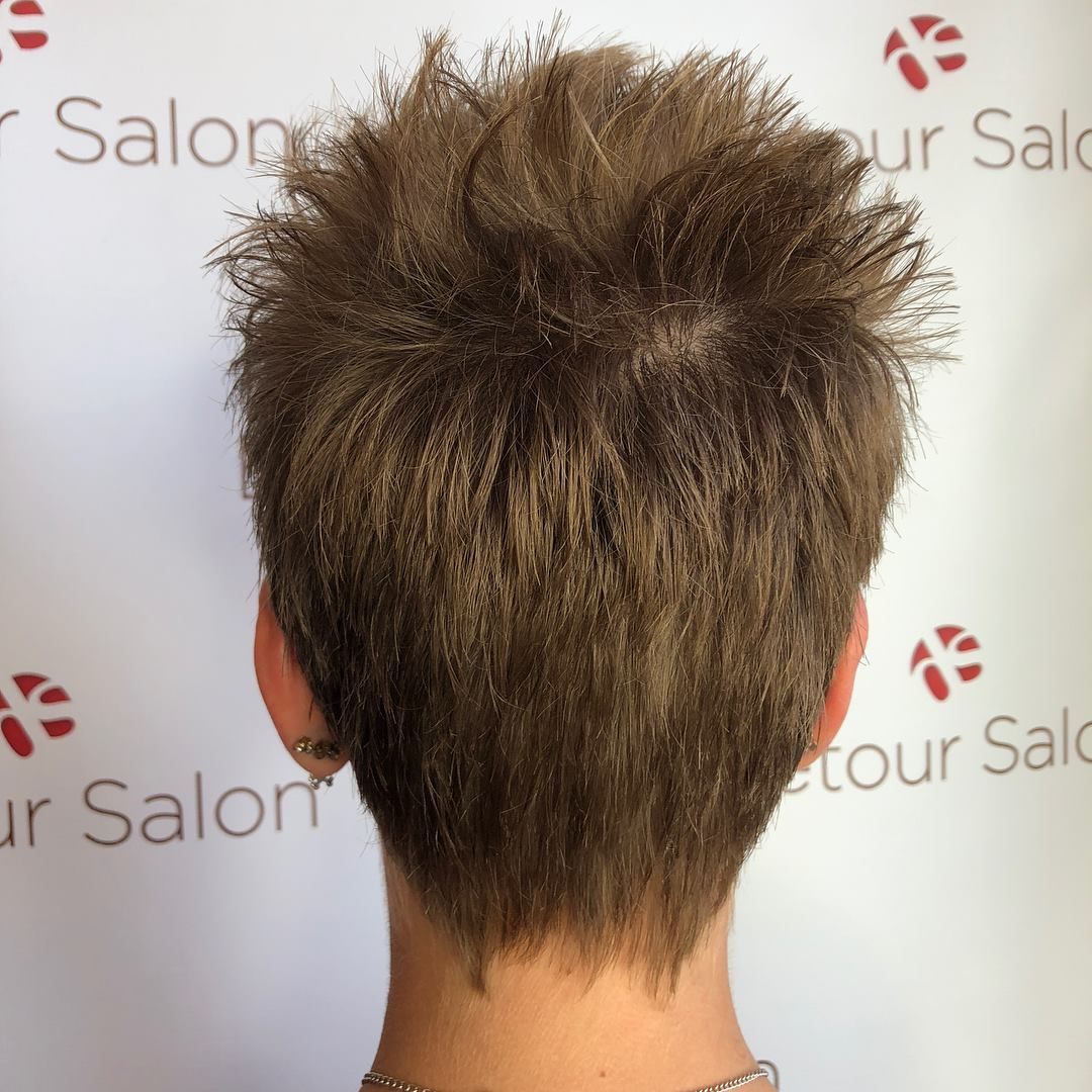 Close-up of the back of a person's head with short, spiky brown hair.
