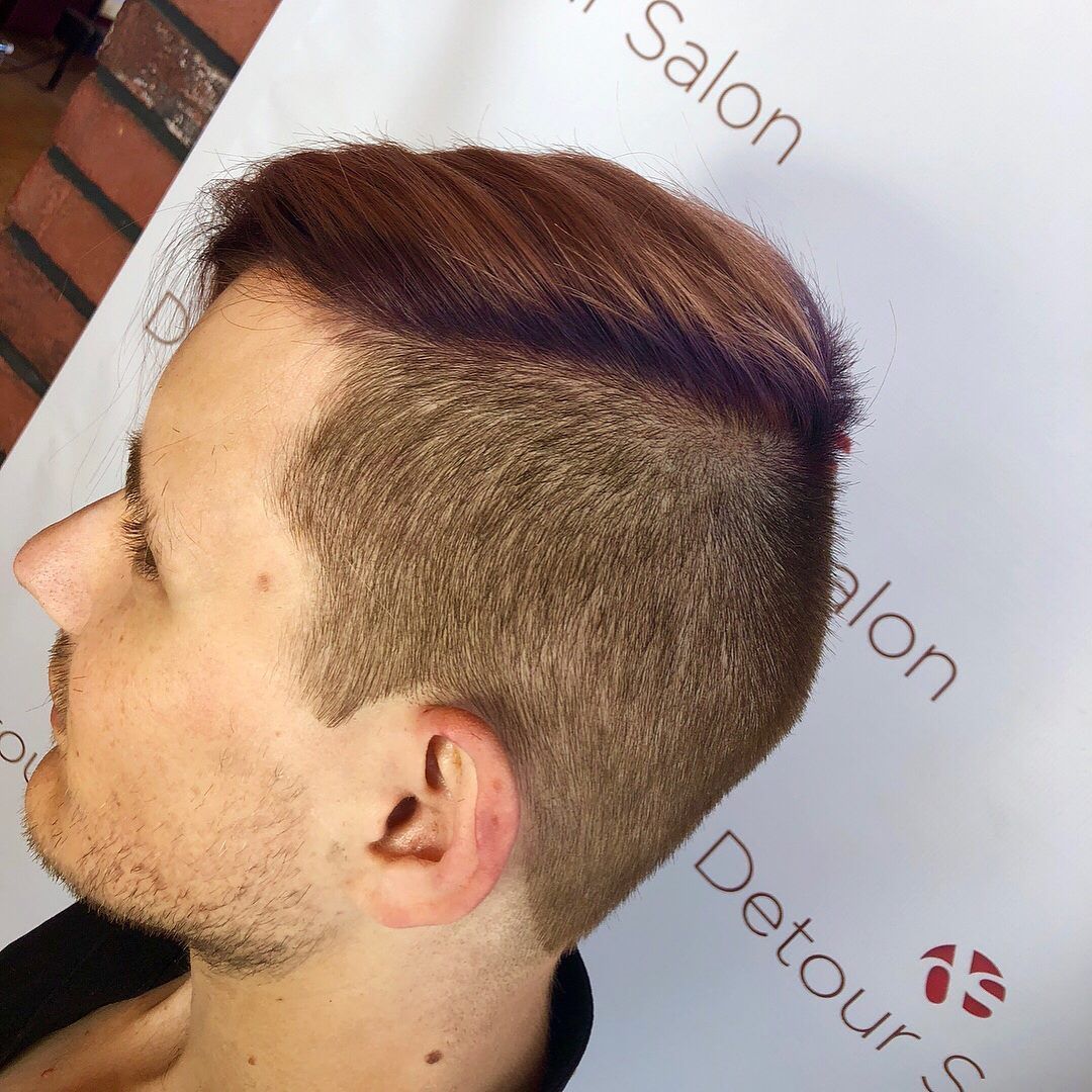 Man with a reddish-brown, neatly styled, and short, light brown hair cut at a salon, profile view.
