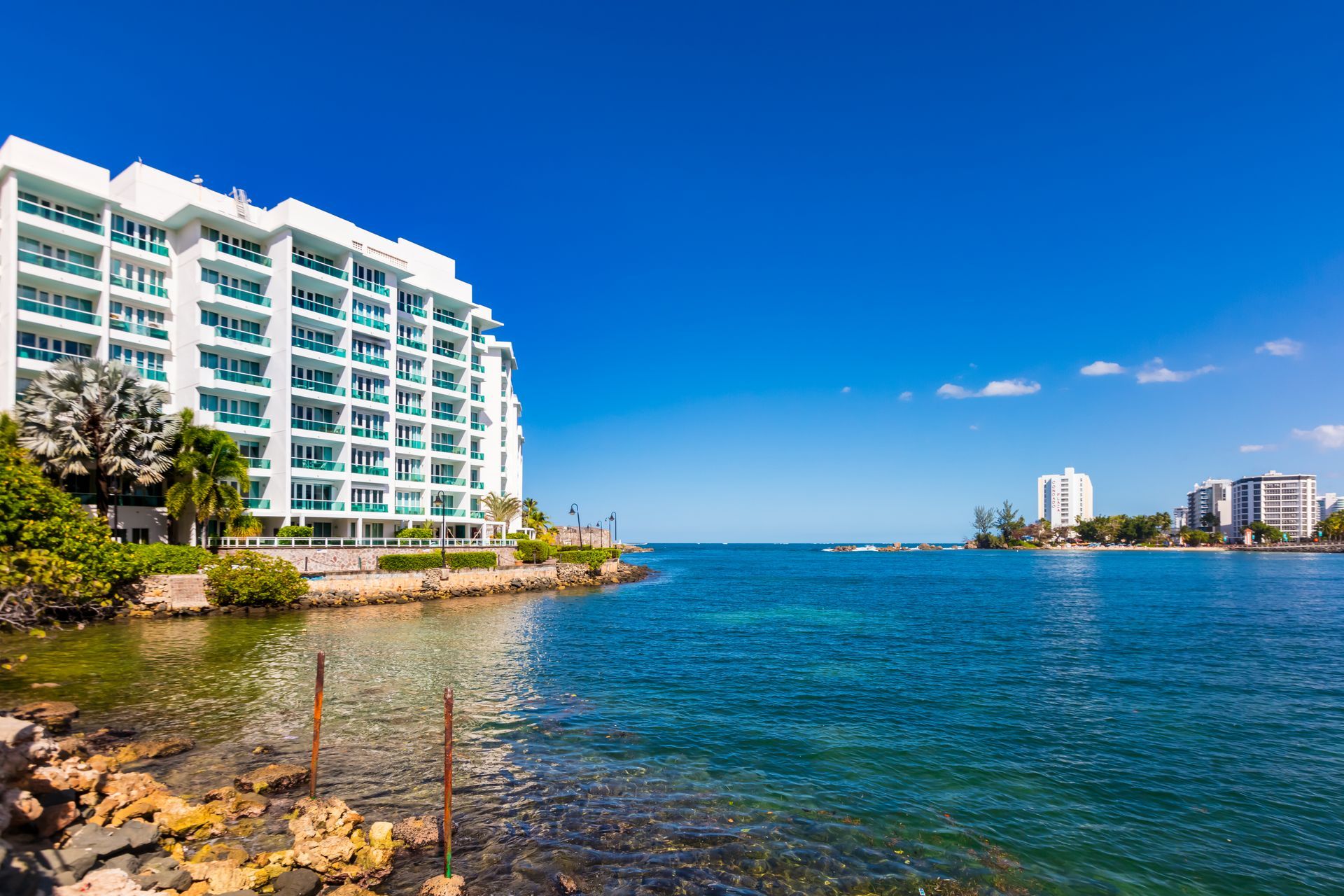 Poolside table with a Puerto Rico flag overlooking the Condado Lagoon and San Juan skyline in Puerto
