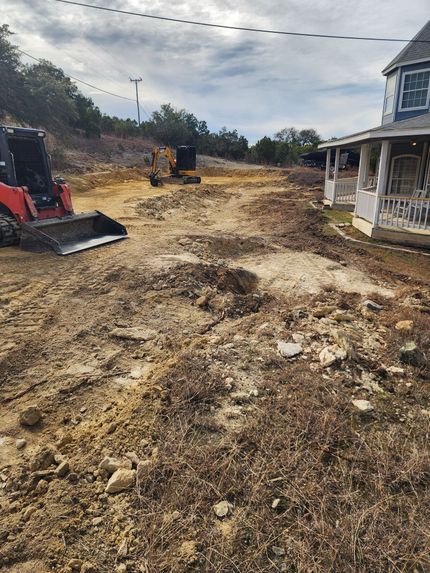 Construction site with heavy equipment, next to a building.