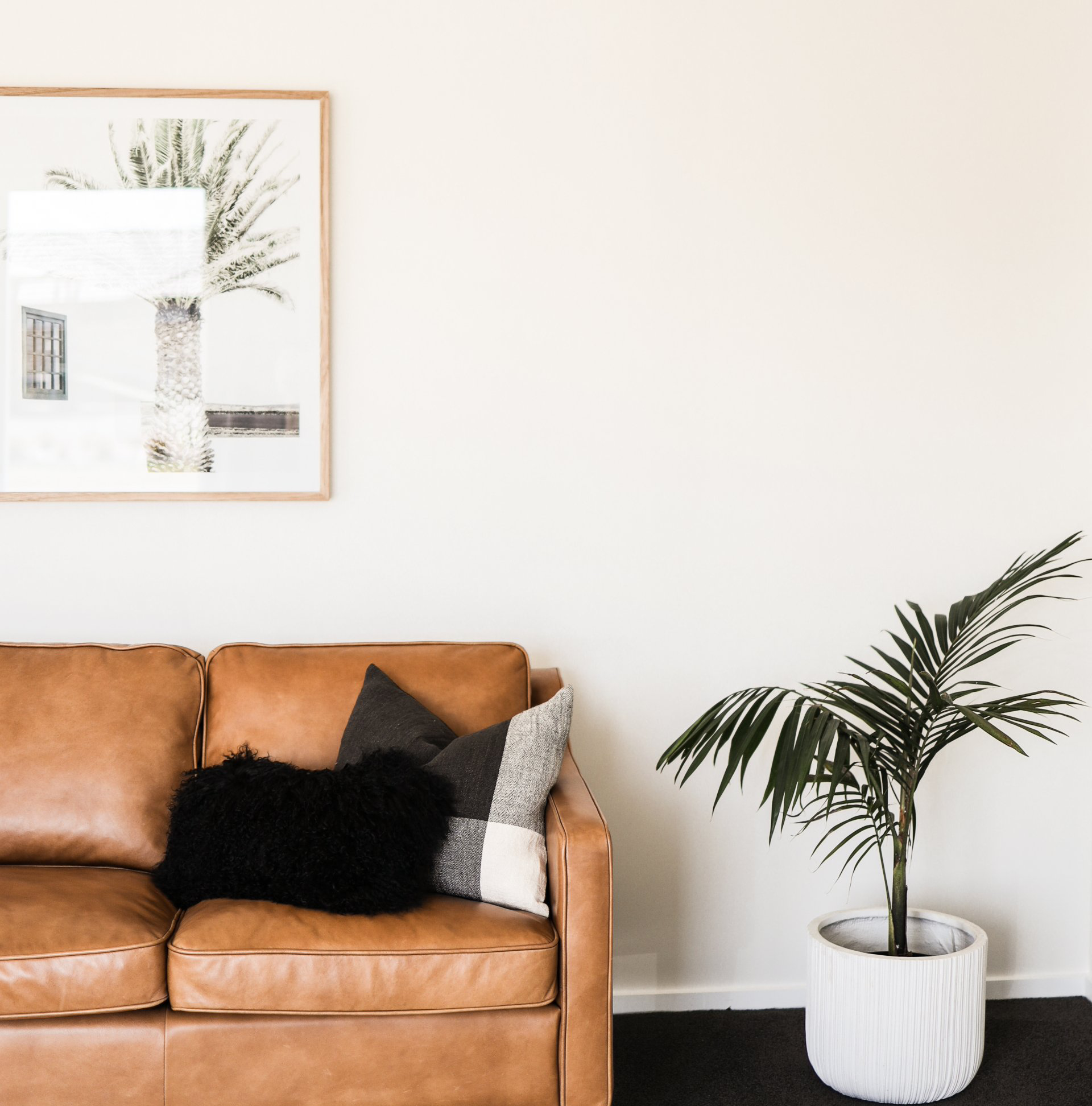 Brown Leather Couch with a Throw and Cushions. Interior Design - Feather and Oak Interiors Rangiora, Christchurch